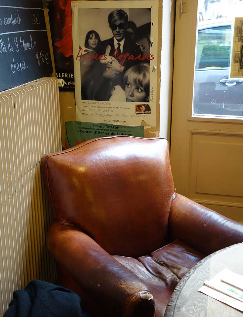 パリのマレ地区にあるカフェ"LE LOIR DANS LA THÉIÈRE"の店内に置いてある皮のクラブソファー。座面がくたくたになっている。